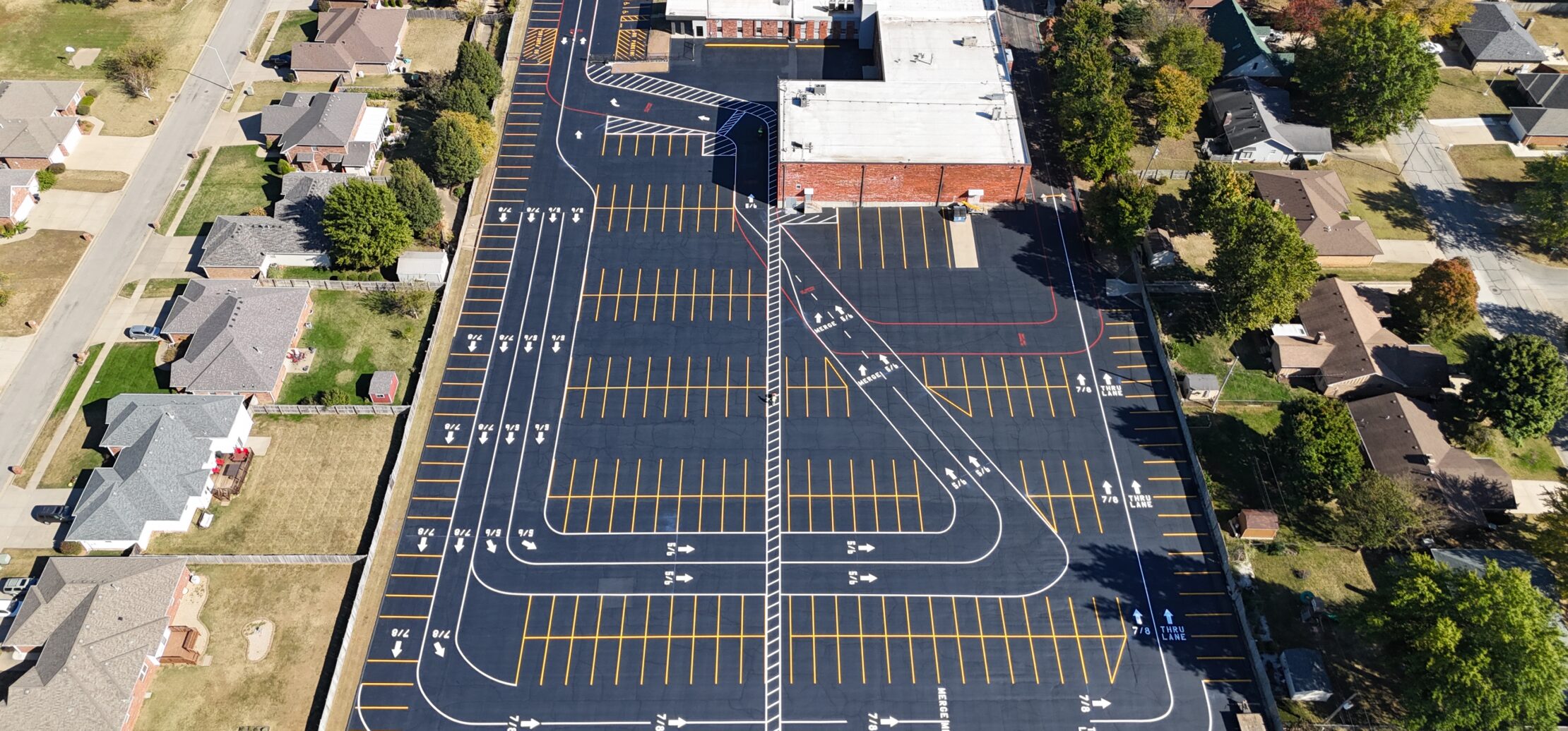 Aerial view of large school lot, courts, and field.