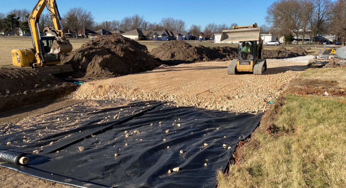 Equipment clearing land to prepare for paving.