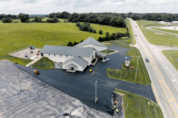 Birds eye photo of a church next to a busy road.