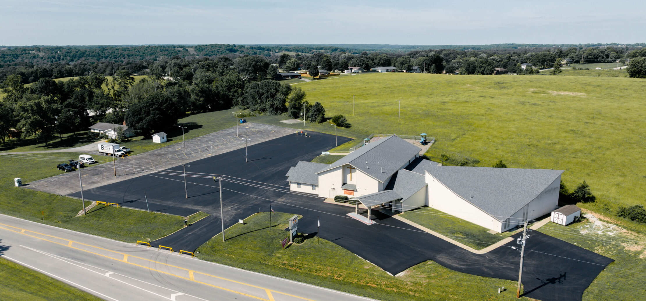 Birds eye photo of a church next to a busy road.