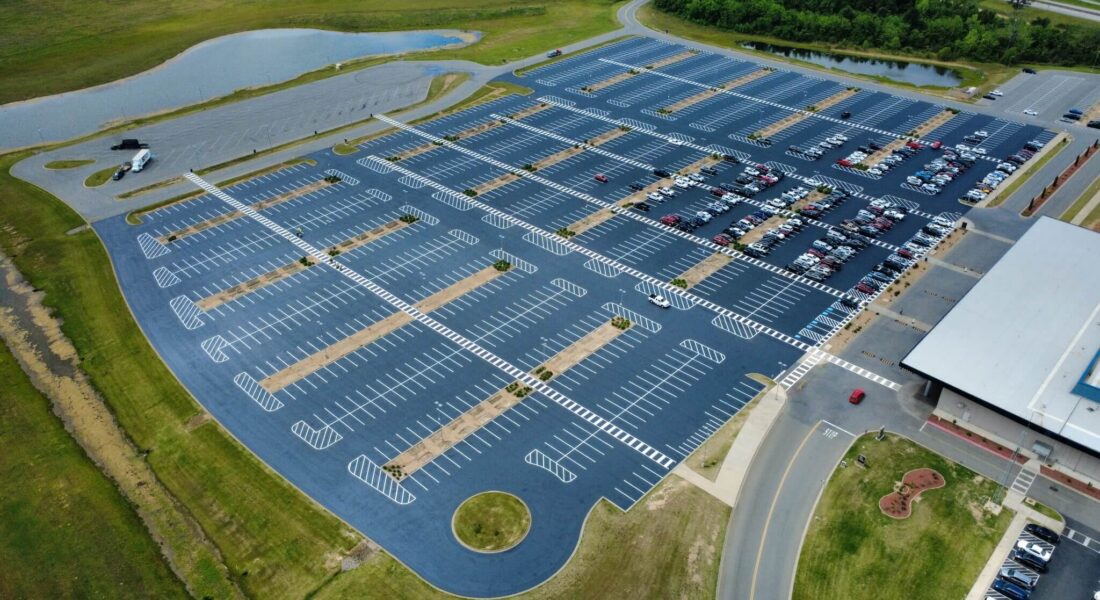 Birds eye shot of a newly paved parking lot with white parking spots.