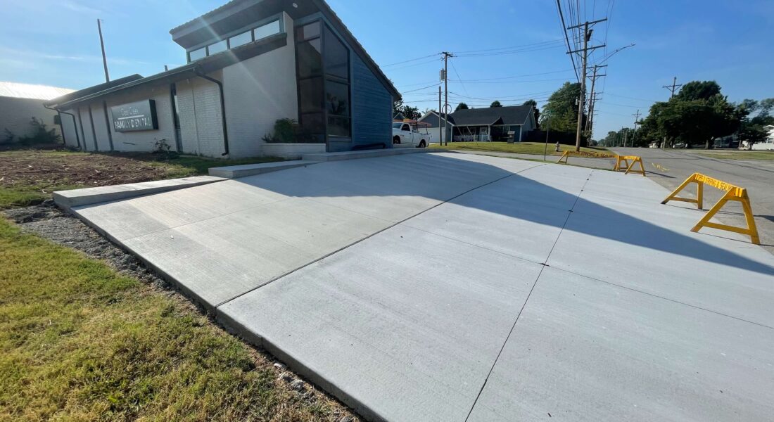 New concrete slab laid next to a building.