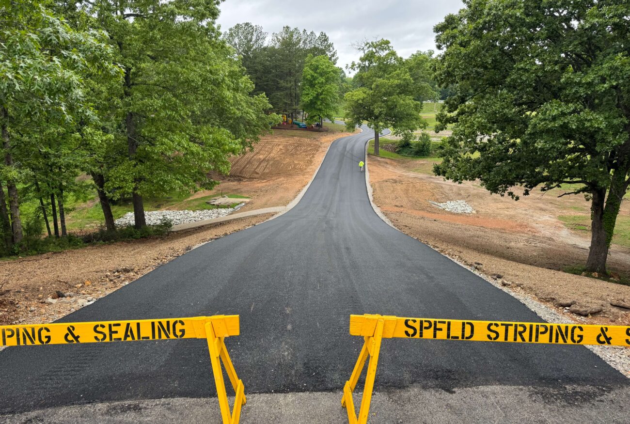 A long driveway freshly paved. 