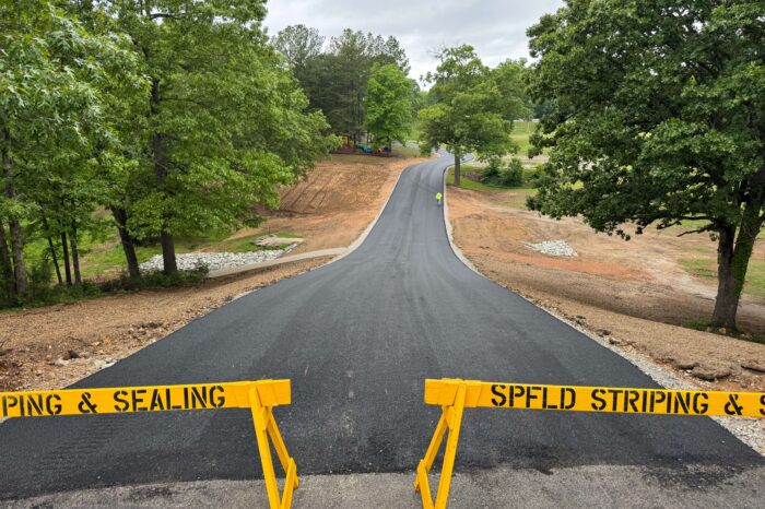 A long driveway freshly paved. 