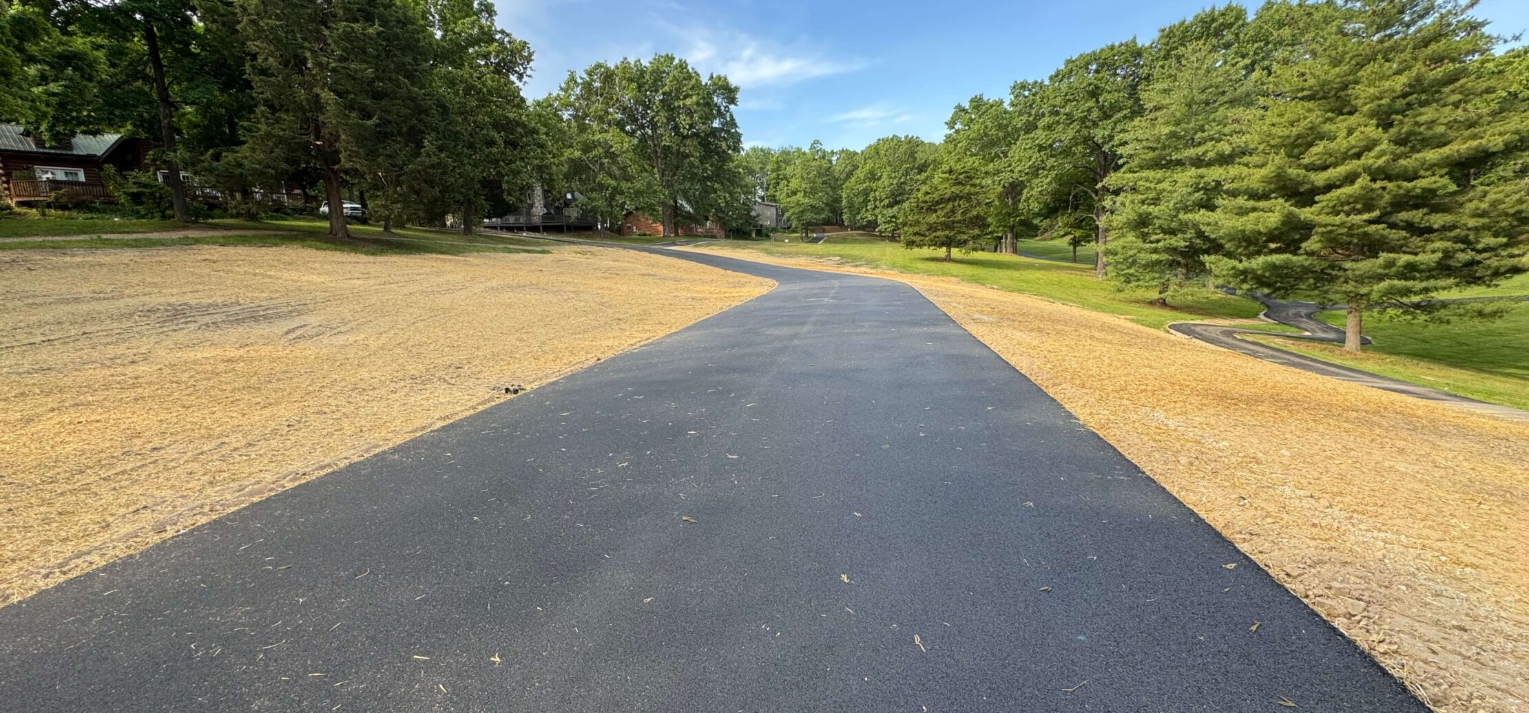 A long driveway freshly paved. 