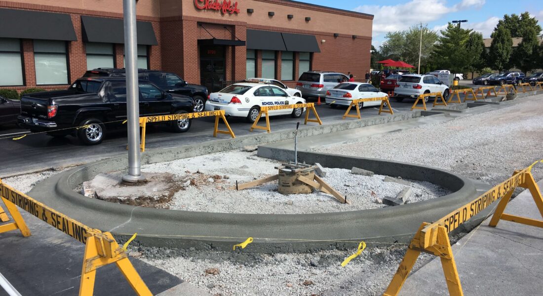 Construction barriers up around a Chick-fil-a parking lot.