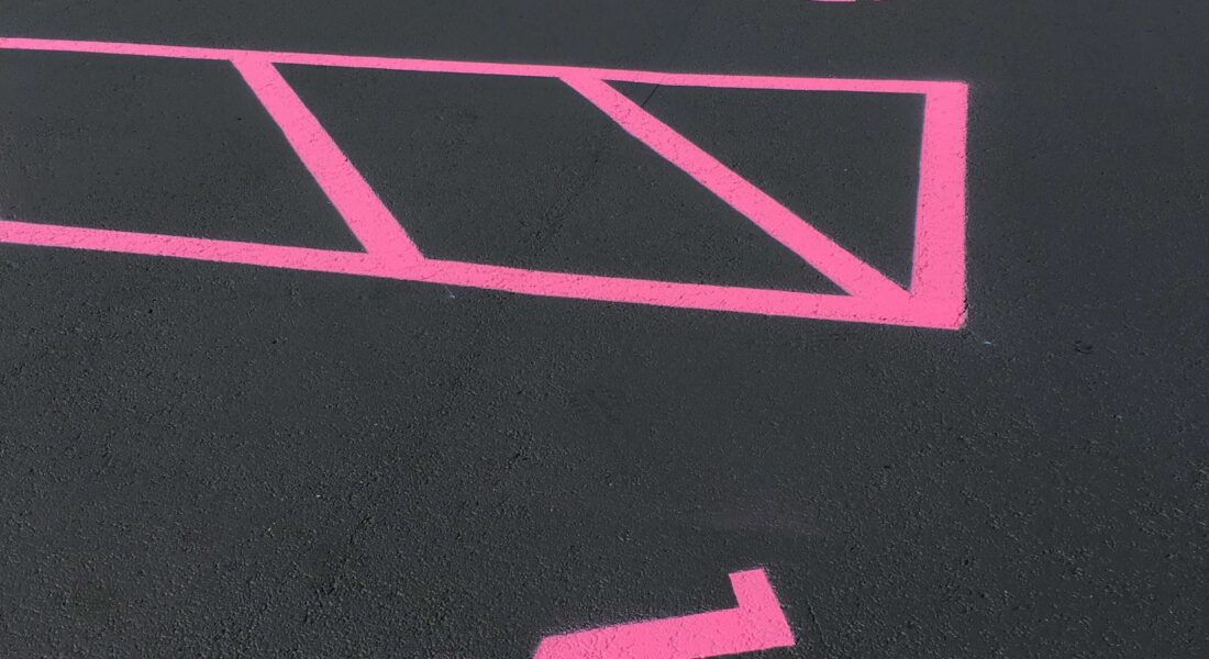 Photo freshly painted pink handicapped parking spots.