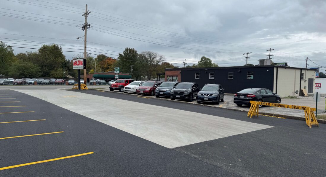A newly paved parking lot in front of a Papa Johns Pizza.