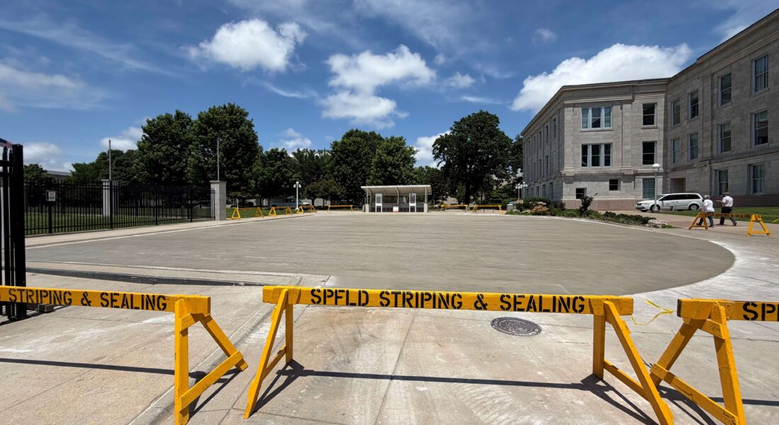 SPFD Striping & Sealing barriers in front of new concrete parking lot.